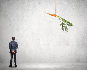 Funny image of businessman chased with carrot